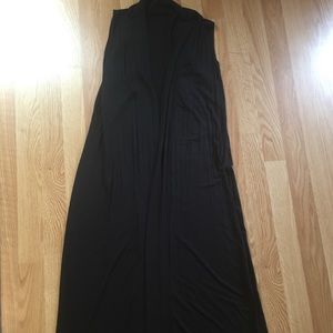 Long black sleeveless vest. Great layering piece!